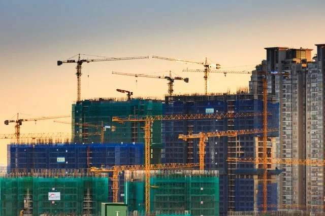 Construction site with cranes at sunset